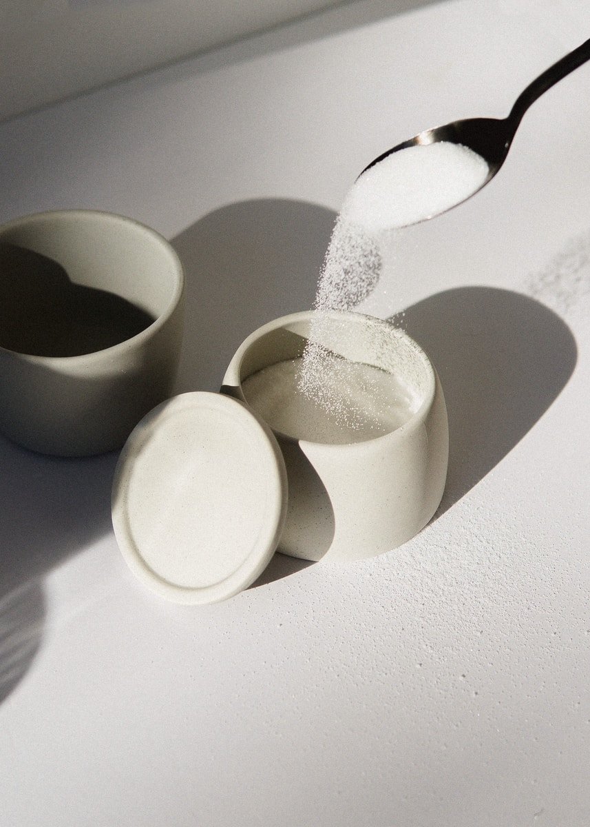 white ceramic mugs on white table